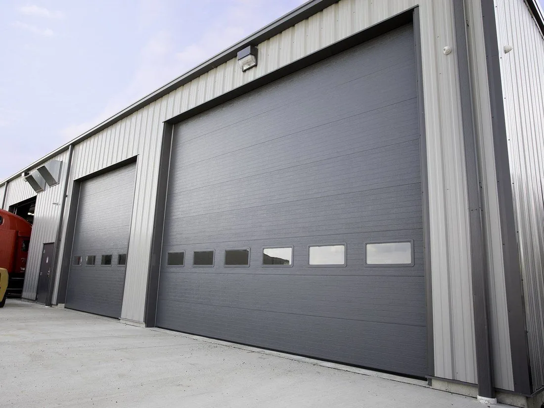 Haas Door charcoal insulated commercial doors on a steel shop building